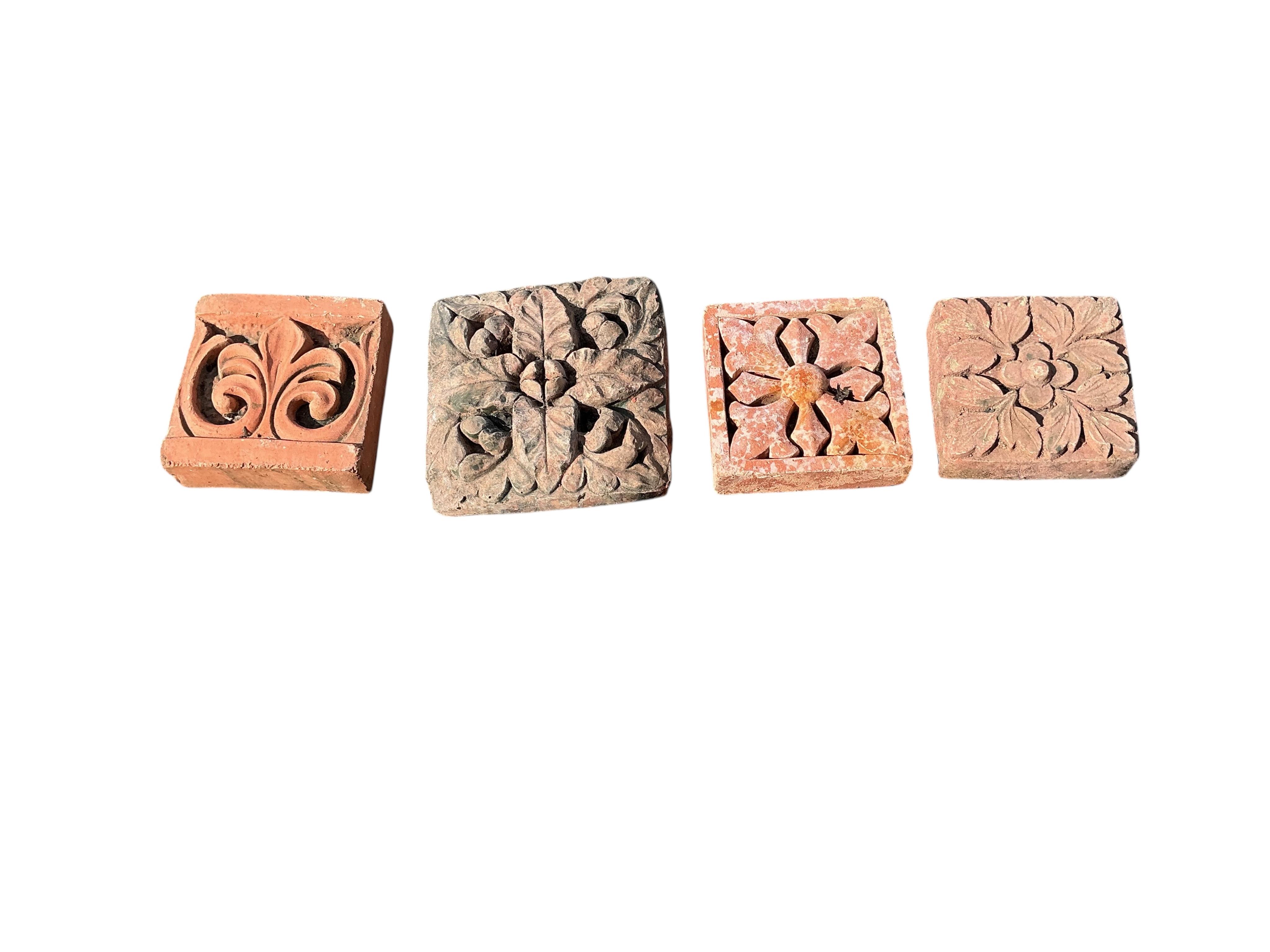 Eleven terracotta tiles, largest 22 x 24cm